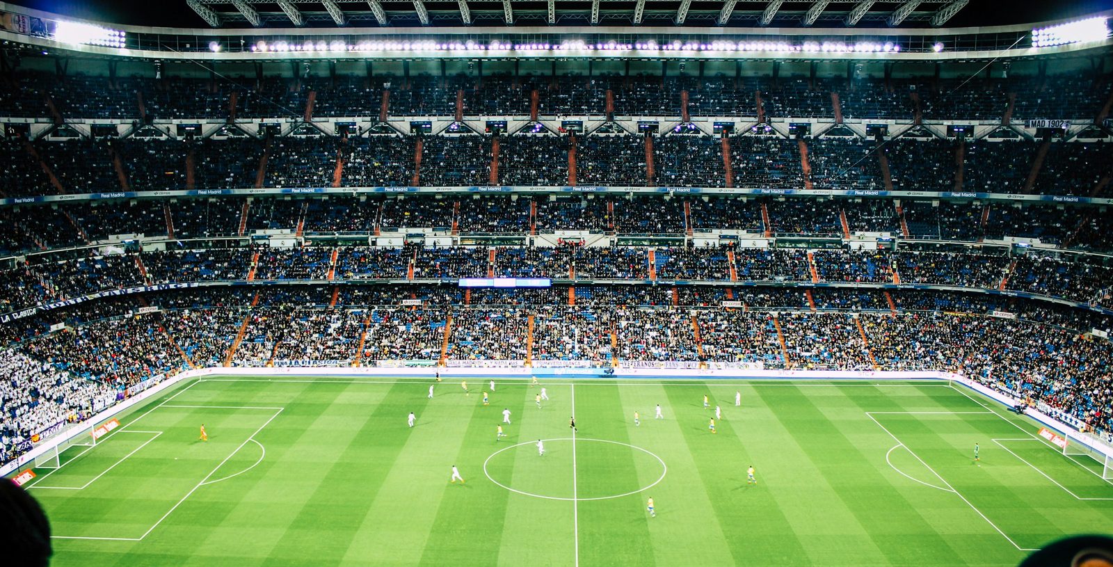 A packed football stadium under floodlights, streamed live on ottocean